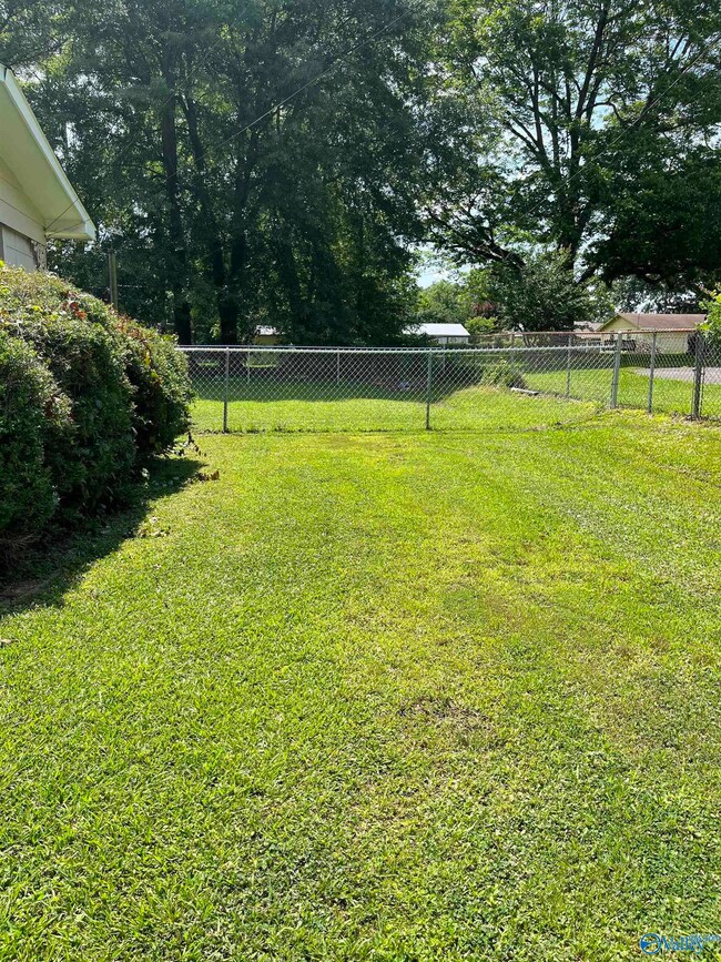 View of back yard which is partially fenced
