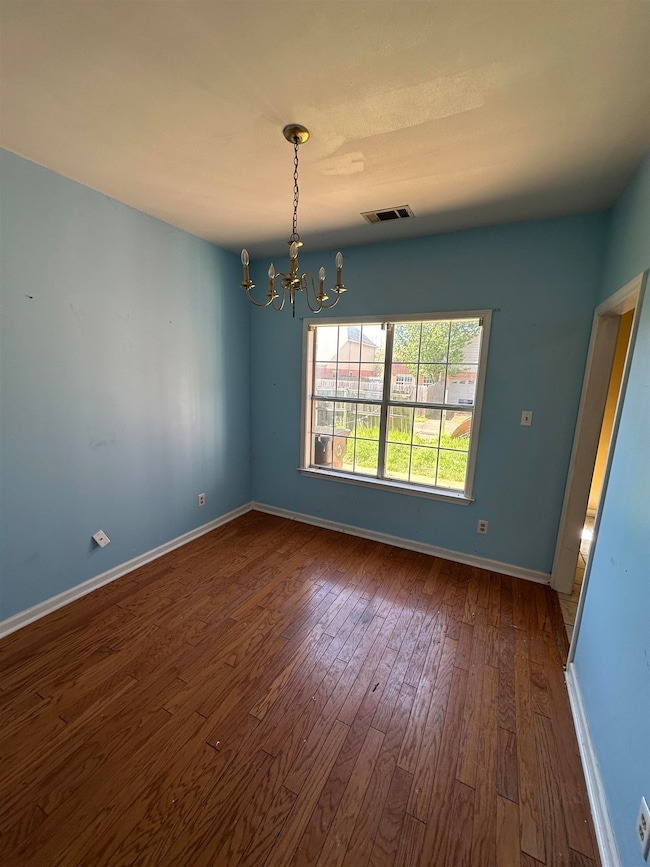 Spare room with a notable chandelier, visible vent
