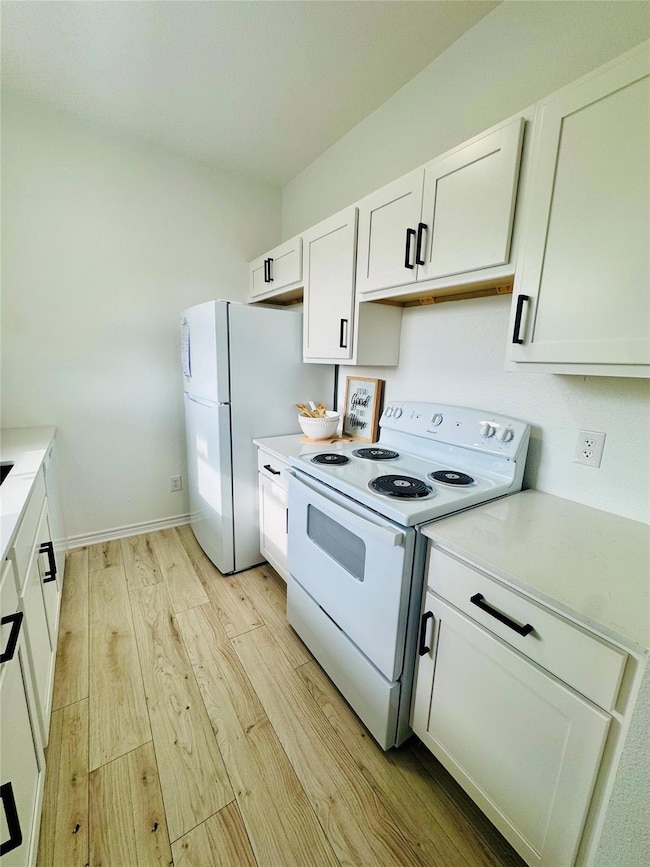 Kitchen with light countertops, light wood finish