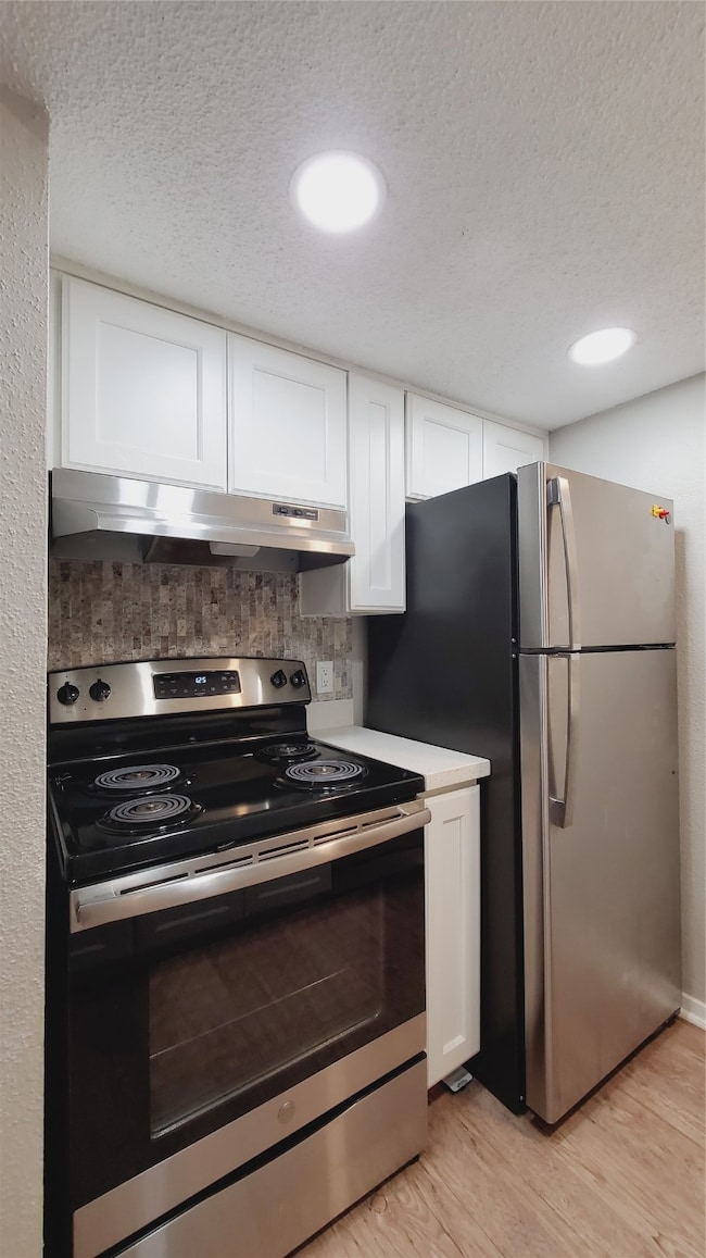 Updated kitchen with new finishes; refrigerator stays with the home.
