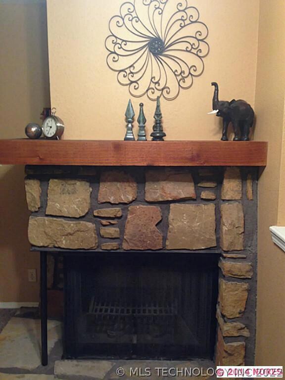 Close up of woodburning fireplace, hearth, and man