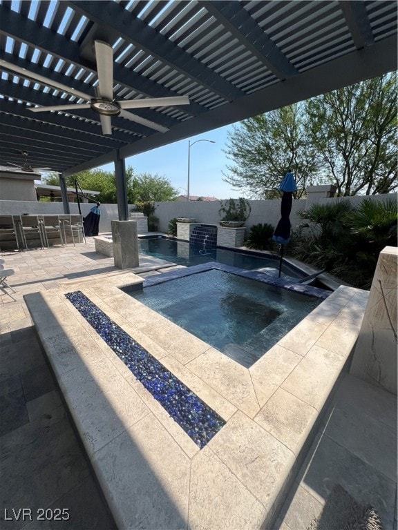View of pool featuring an in-ground hot tub, a per