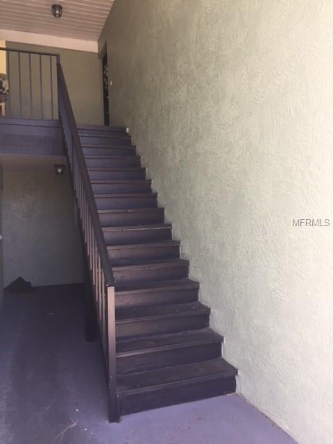 Covered stairwell leading to upstairs unit on righ