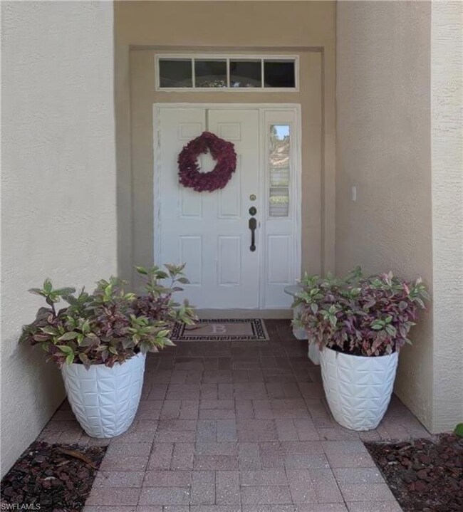 Front entry door featuring stucco siding