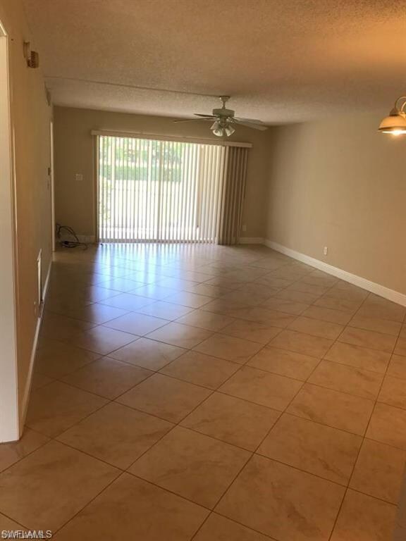 living room with tile on the diagonal