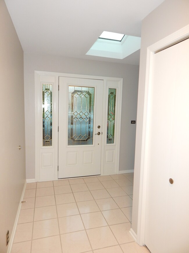 Leaded glass door and side lights welcomes you int