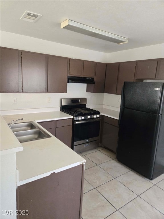 Kitchen featuring freestanding refrigerator, stain