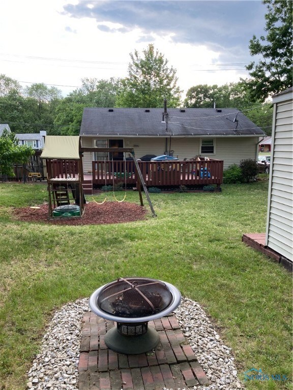 Back of house, swing, fire pit and side of shed.