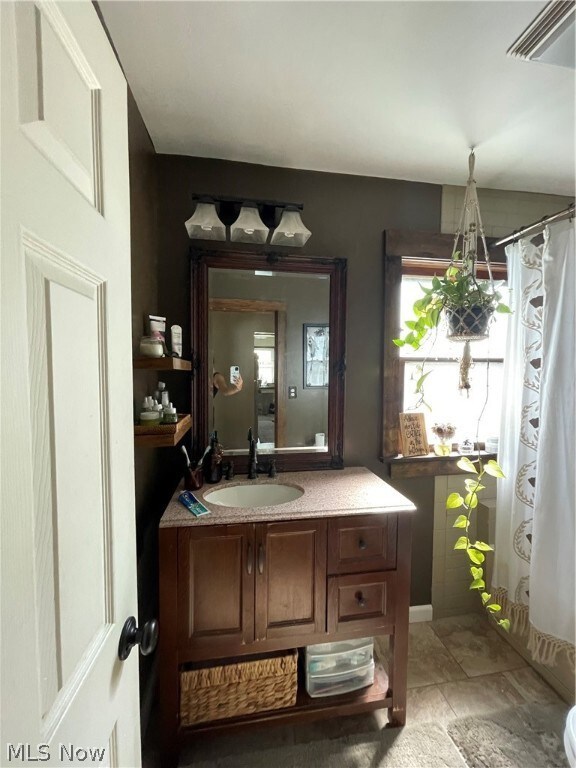Bathroom with tile flooring and vanity