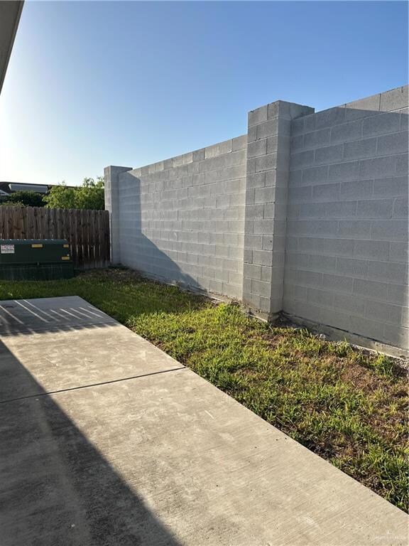 View of patio featuring fence