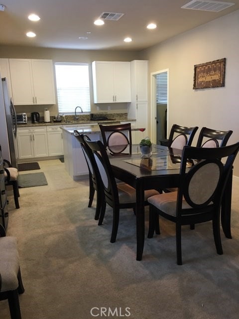 Recessed lights , open kitchen to dining, to the right is the laundry room