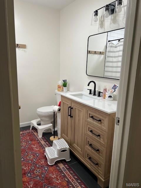 Half bathroom with vanity and toilet