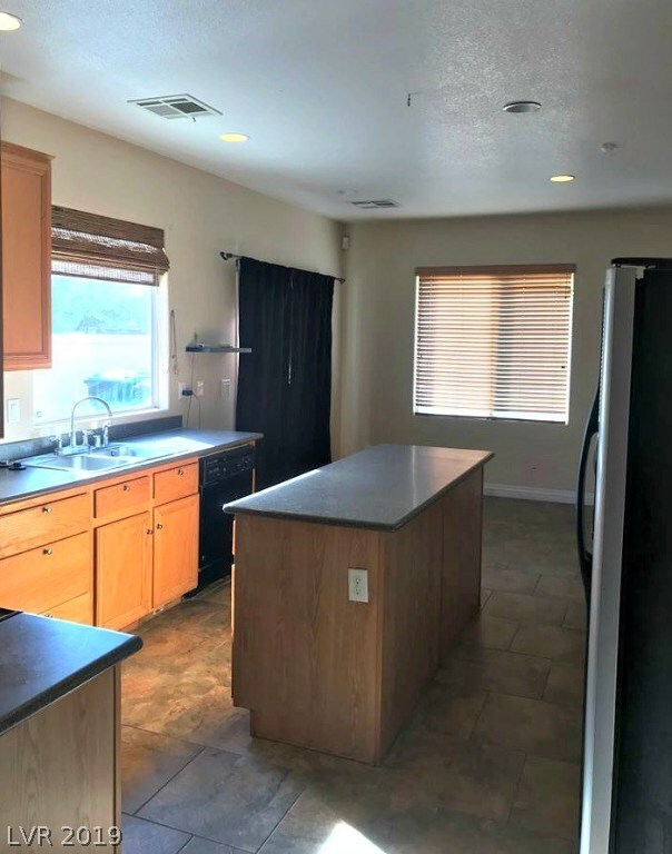 KITCHEN WITH PANTRY AND LOTS OF CABINET SPACE! ROOM FOR A TABLE AND CHAIRS IN KITCHEN, SLIDING DOORS TO BACK PATIO. ALL APPLIANCES INCLUDED AS IS.