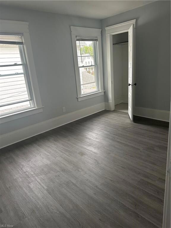 Unfurnished room featuring dark hardwood / wood-style floors