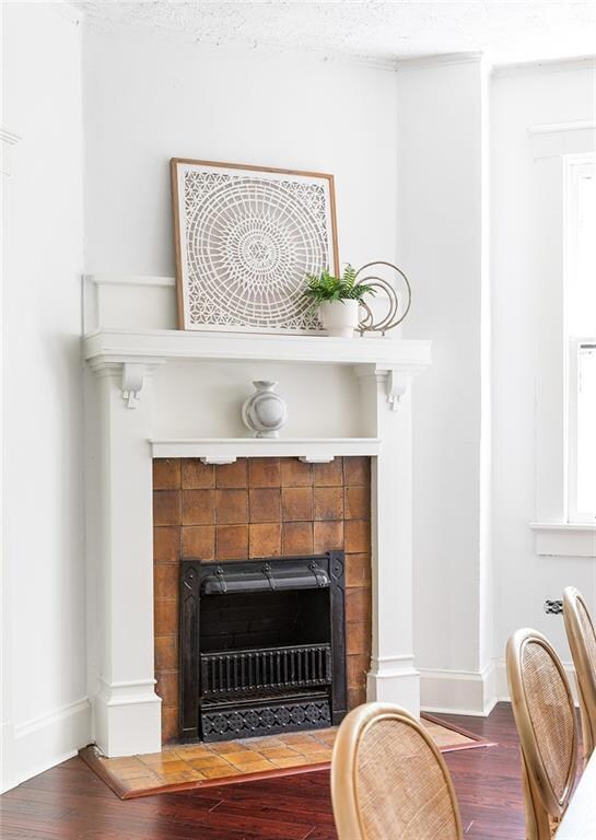 Detailed view of a fireplace and wood finished floors
