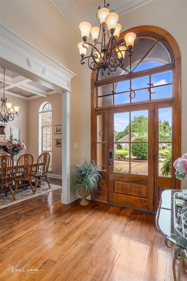 Entrance foyer featuring crown molding, beam ceili
