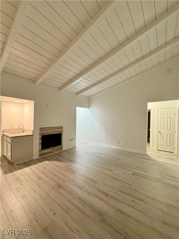Unfurnished living room with lofted ceiling with b