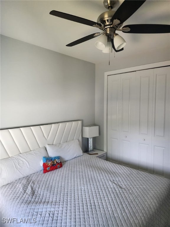 Unfurnished bedroom with ceiling fan and a closet