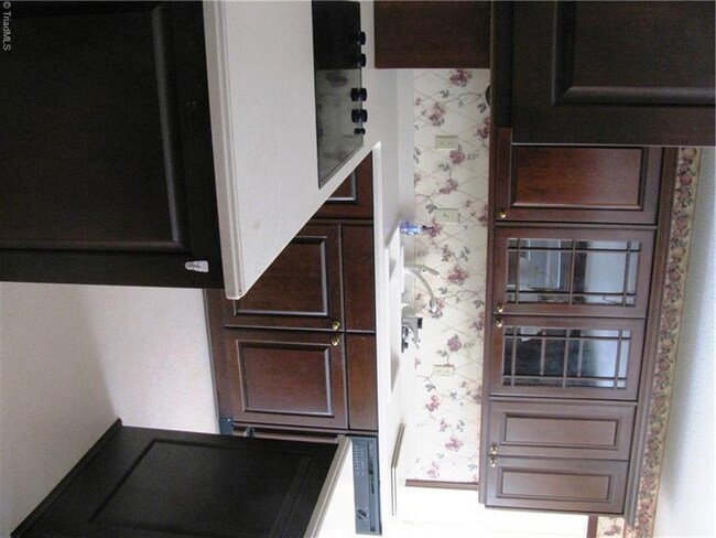 Kitchen  stove top and cabinets with glass doors