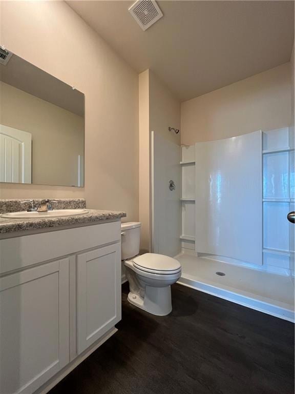 Full bath featuring toilet, wood finished floors, 