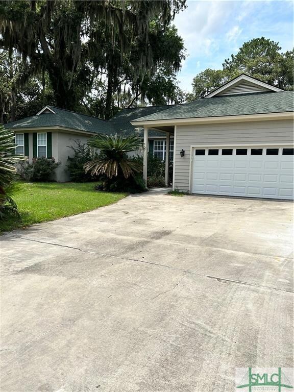 Large 2car garage, with shelving and garden  door.