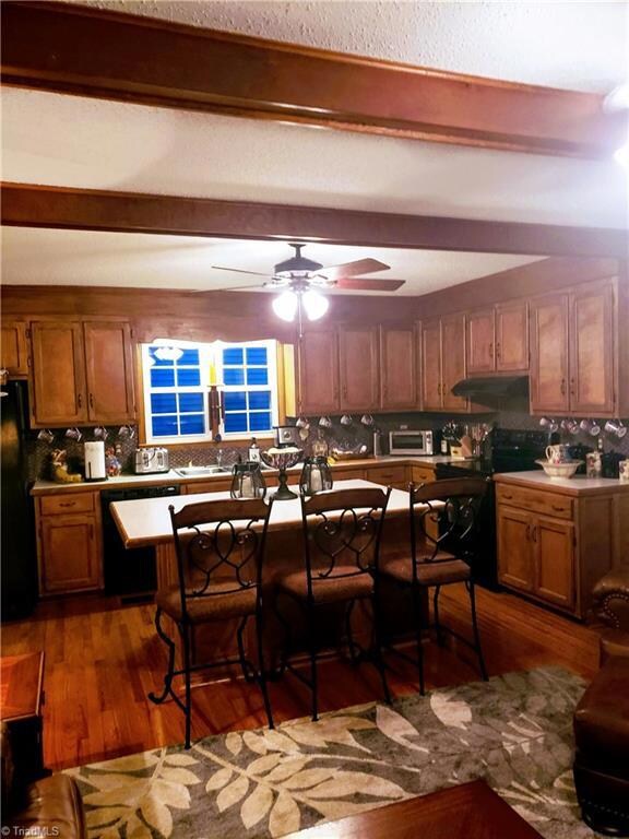 Custom Teak Cabinets in this open floor plan family room and kitchen combo