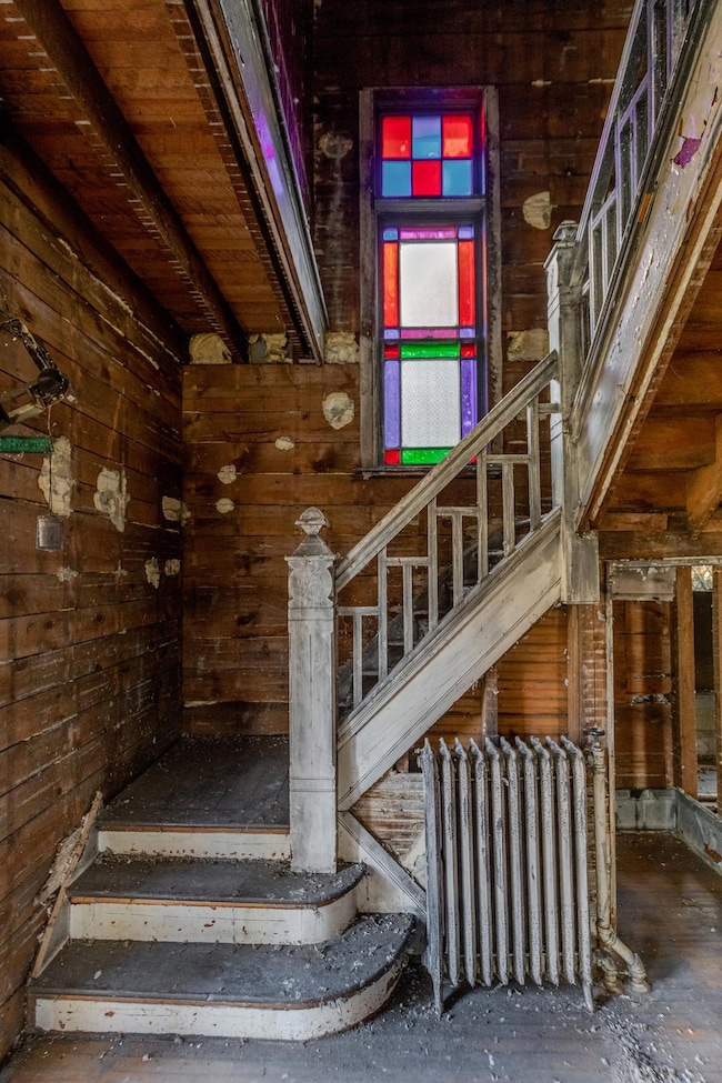 Grand staircase with stained glass window.