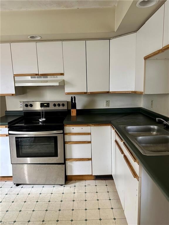 Kitchen featuring light tile flooring, stainless s