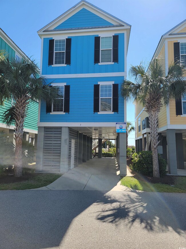 Coastal inspired home with a carport, board and ba