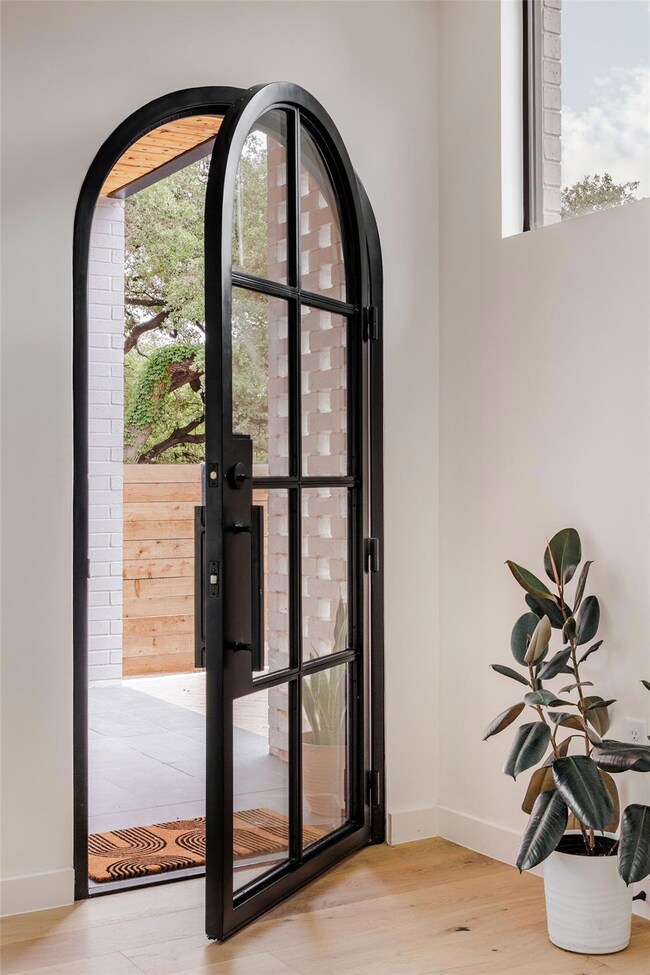 Entryway with wood finished floors, baseboards, a