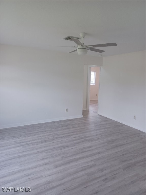 Spare room featuring baseboards, a ceiling fan, an