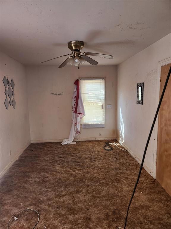 Empty room with ceiling fan and carpet flooring
