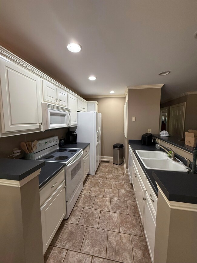 Kitchen featuring ornamental molding, dark counter
