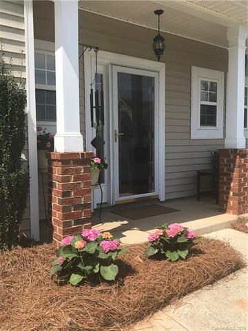 Front covered porch and storm door.
