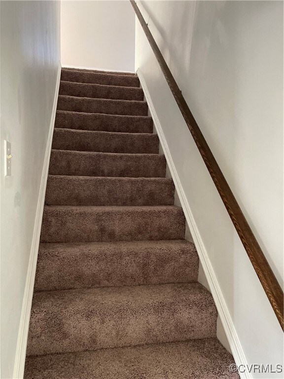 Stairway featuring carpet