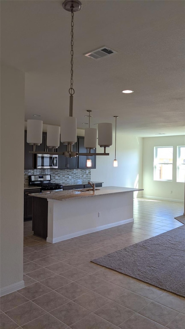 Kitchen with tile patterned floors, tasteful back