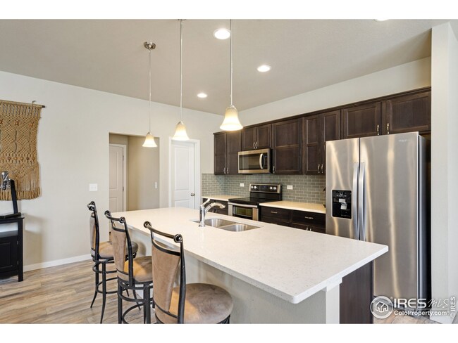 Quartz counters, full tile backsplash, double oven