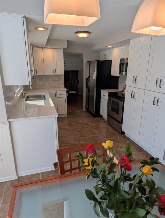 with bright white cabinetry, quartz counters & sta