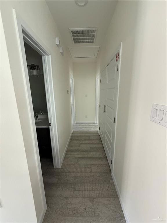 Hall with wood finished floors and baseboards