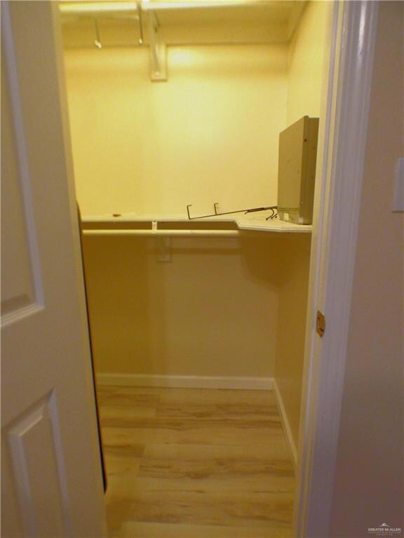 Spacious closet with light wood-type flooring