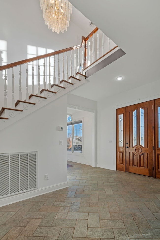 Notice the solid wood front door with etched and beveled glass.