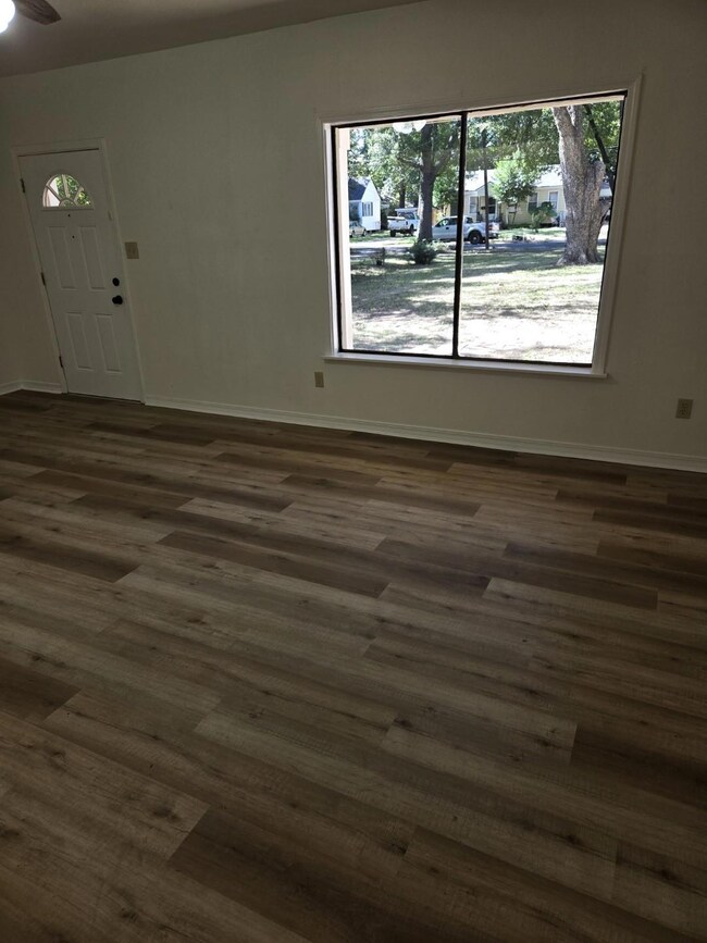 Large living room with picturesque window to allow