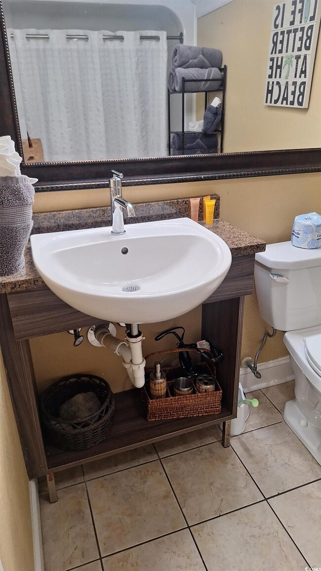 Bathroom featuring toilet and tile patterned floors