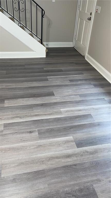 Details with wood finished floors and baseboards