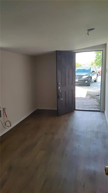 Foyer featuring baseboards and dark wood-style fl