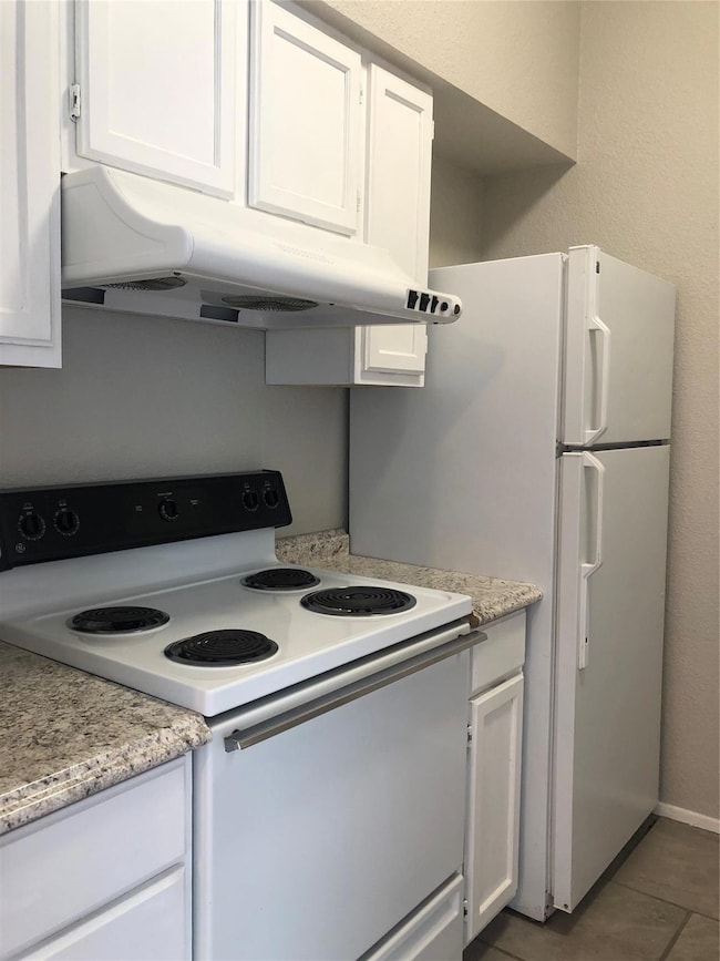 This view of the kitchen shows the white appliance