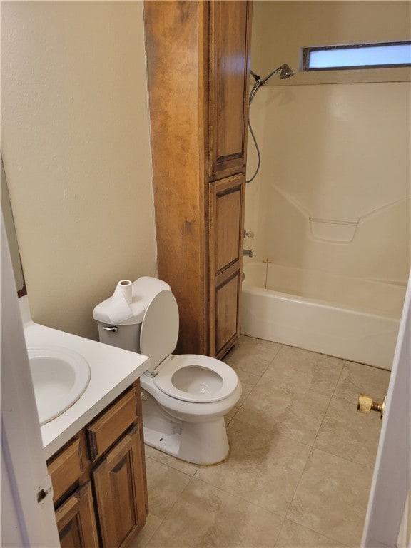 Bathroom with toilet, vanity, tile patterned floor