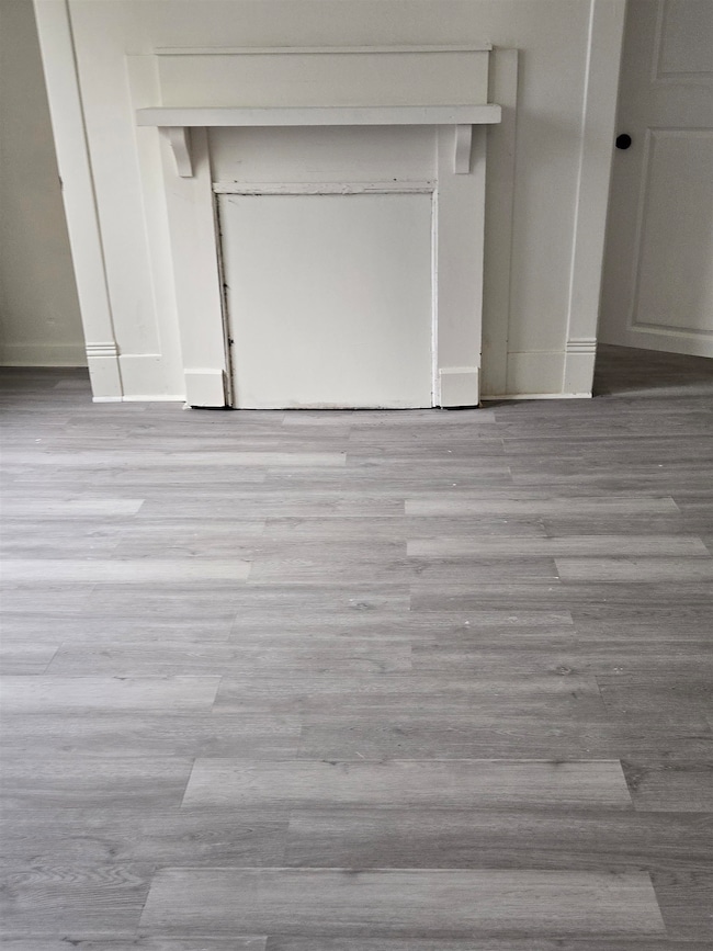 Detailed view of wood finished floors and baseboards