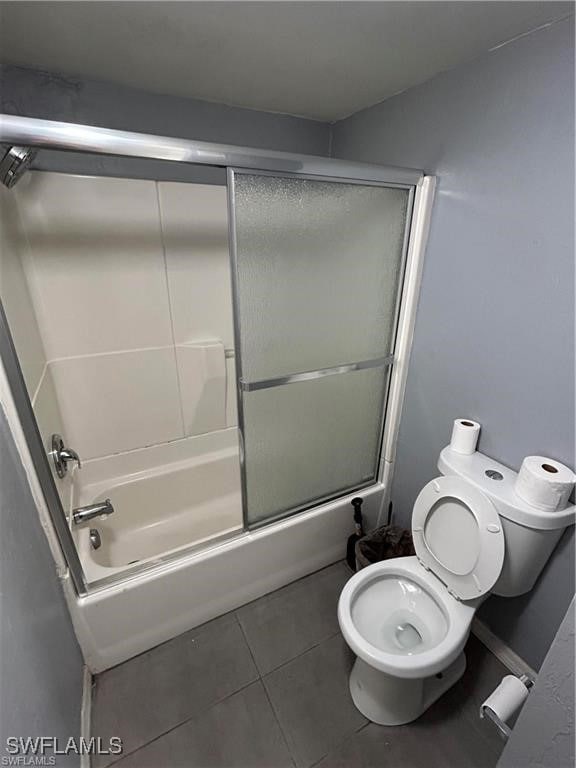 Bathroom featuring tile patterned flooring, toilet
