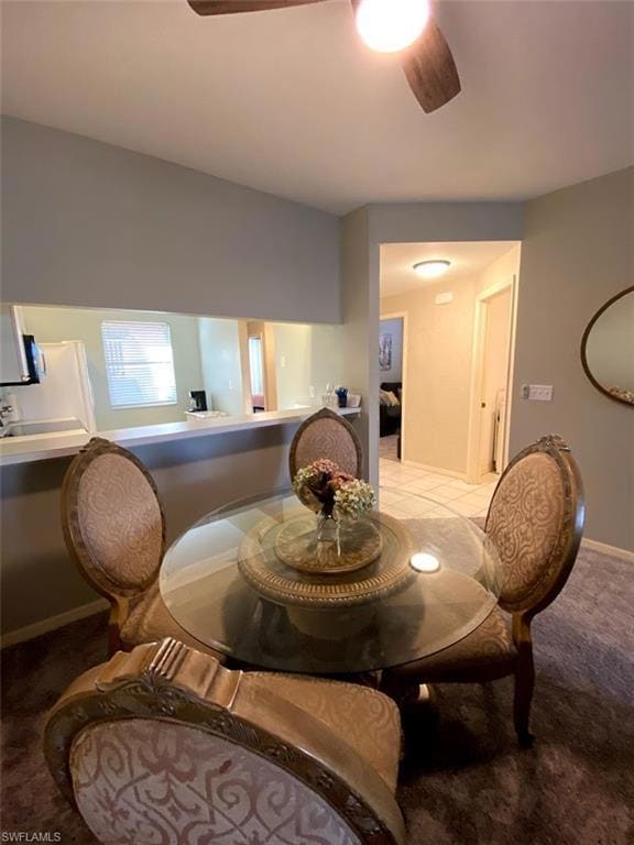 Dining area with light carpet and ceiling fan